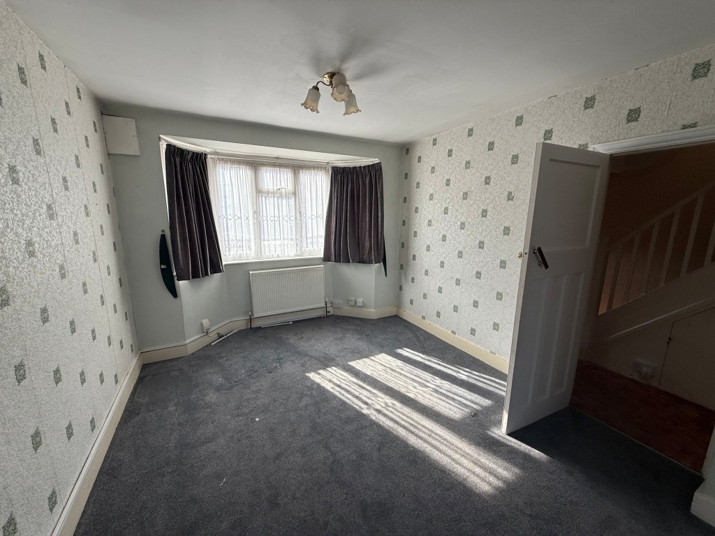 Lot: 226 - THREE-BEDROOM SEMI-DETACHED HOUSE FOR IMPROVEMENT - Living room with radiator and window